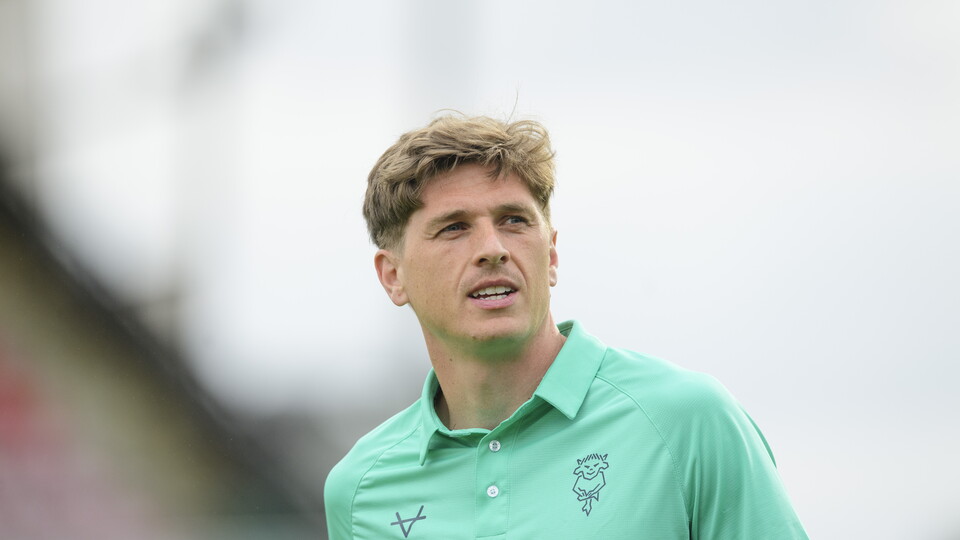 Adam Reach in teal training kit