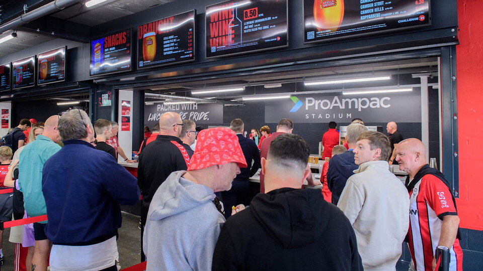 Fans eat and drink in the Fan Village