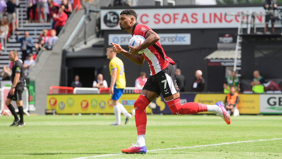 Reeco Hackett celebrates scoring from the penalty spot against Portsmouth