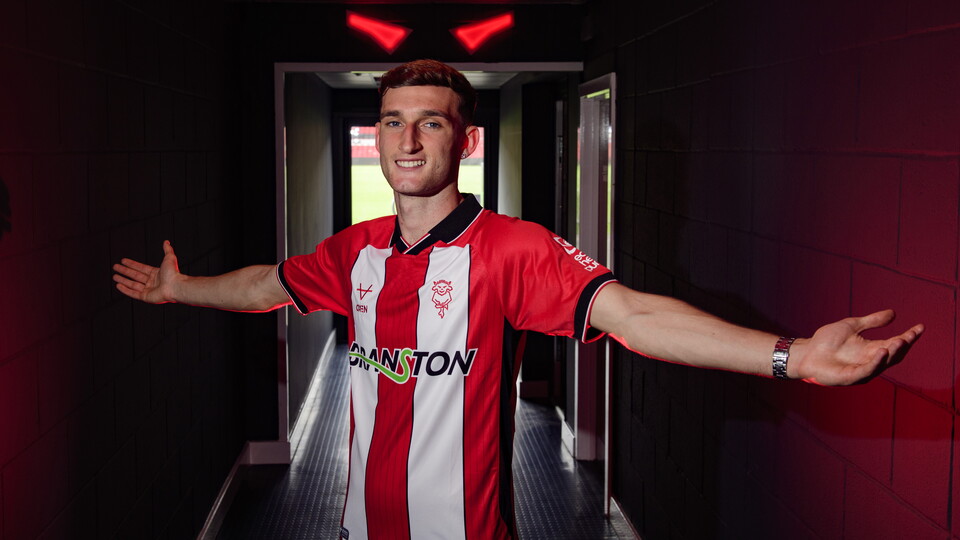 Mason Melia stands in a darkened tunnel holding his arms out
