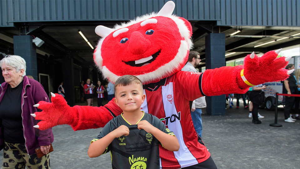 Poacher the Imp poses with a young Imps supporter