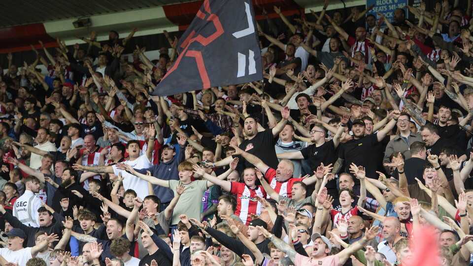 Lincoln City supporters celebrate a goal