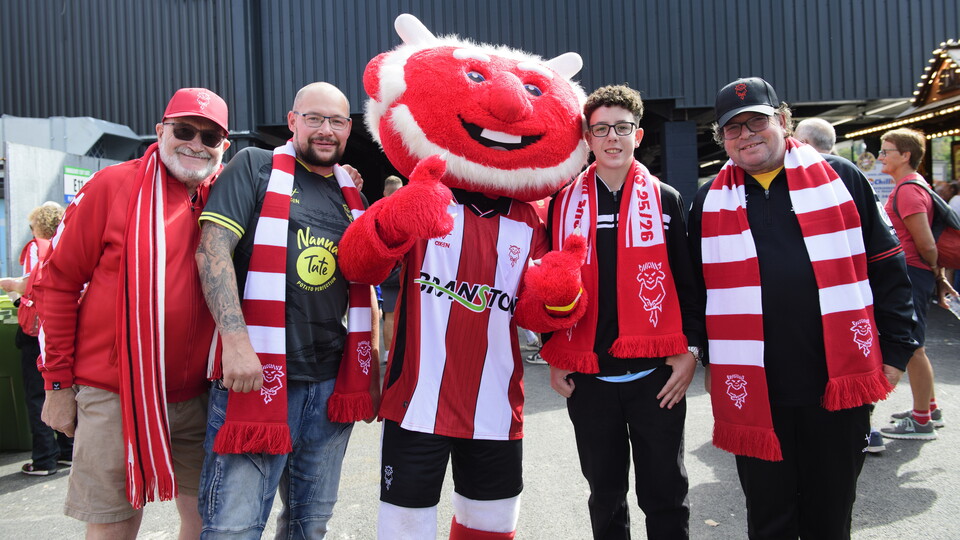 Lincoln City supporters pose with Poacher the Imp