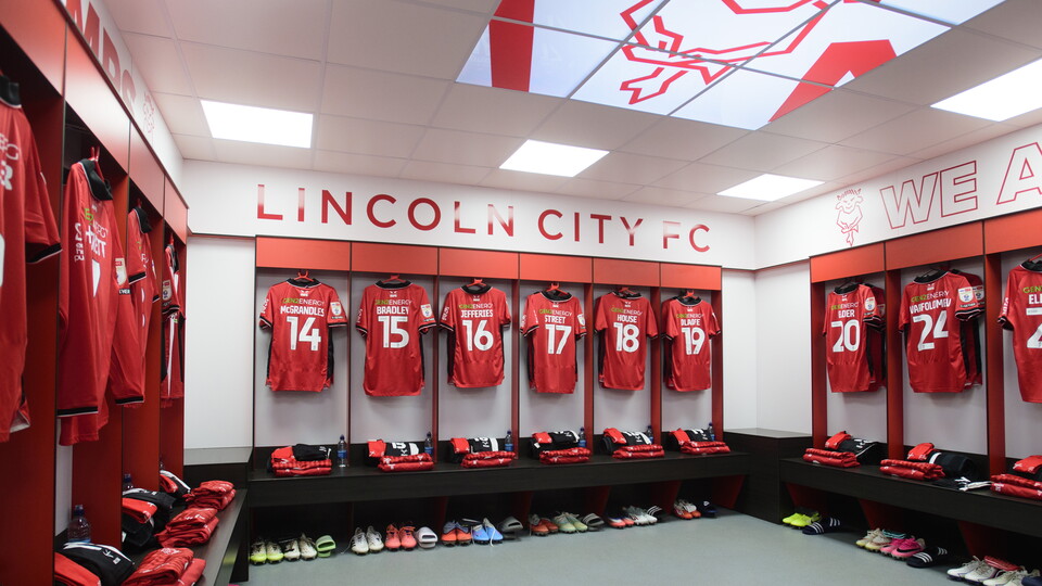 A number of shirts hung up in a changing room