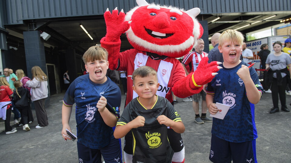 Poacher the Imp poses with three young boys